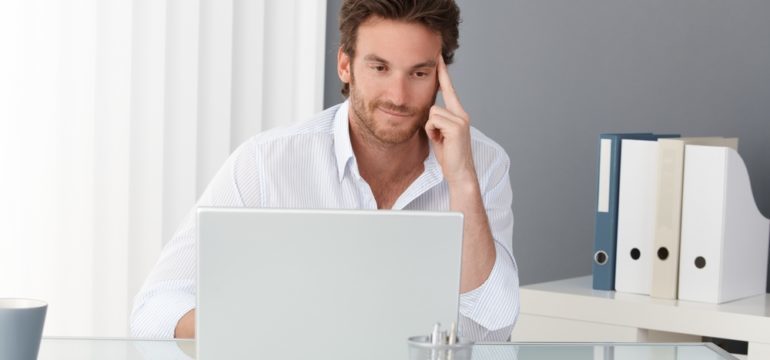 Single gentleman searching or a home on his computer. Searching for housing that appeals to singles.