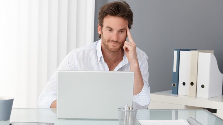 Single gentleman searching or a home on his computer. Searching for housing that appeals to singles.