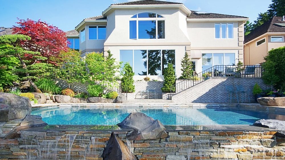 Luxury home with an in-ground pool in backyard.