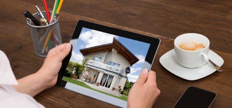 Home Buyer Looking At House Photo On Digital Tablet with Top-Quality Photos