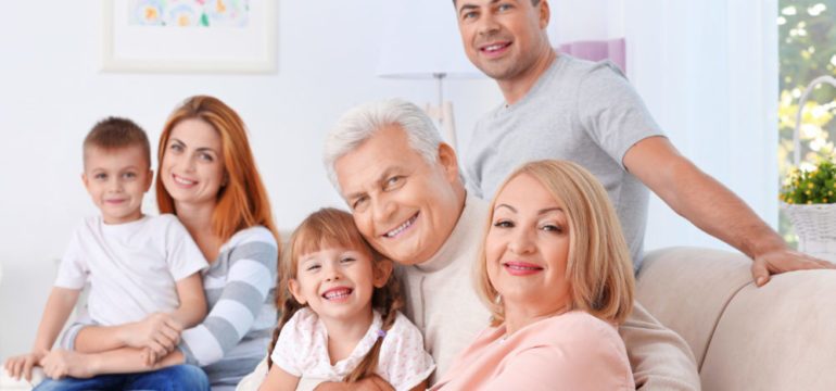 Big happy multiple generations of family sitting on couch.