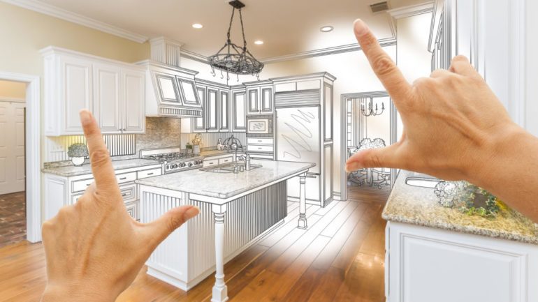Female hands framing custom kitchen with luxury upgrades in a design drawing.