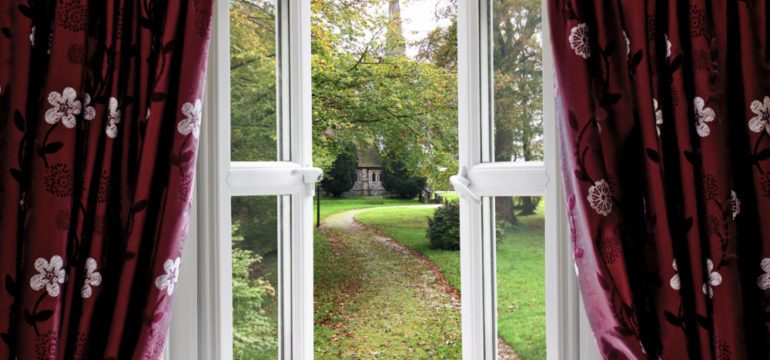 Open window looking out at a garden helps to lower energy bills in the summer.