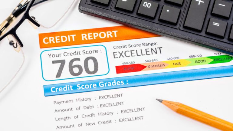 Good credit score report of 760 with calculator, glasses and pencil on table.