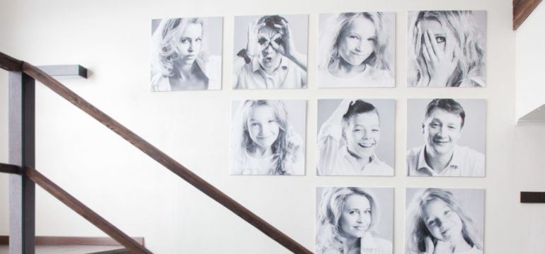 Family photos on hung on the stairwell wall in artistic display.