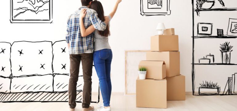 Young couple imagining buying furniture for the interior of new home.