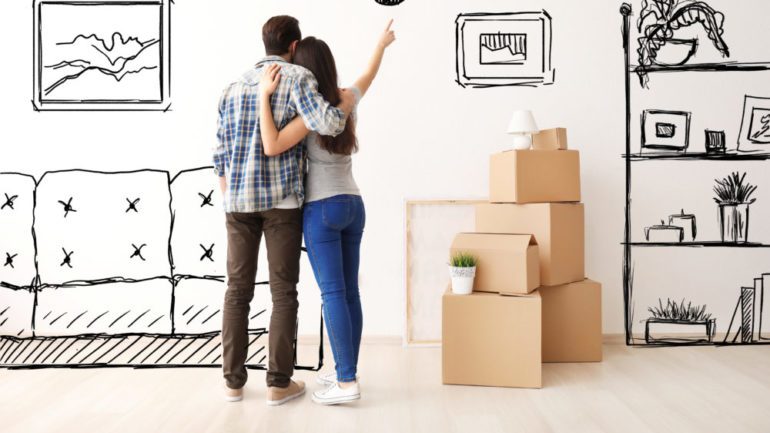 Young couple imagining buying furniture for the interior of new home.