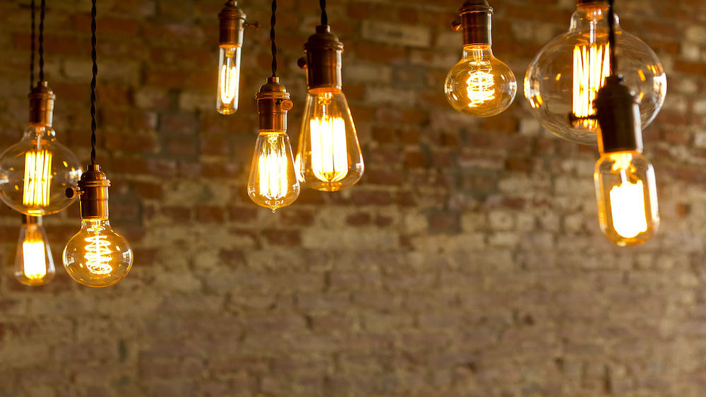 Decorative antique edison style LED light bulbs against brick wall background.