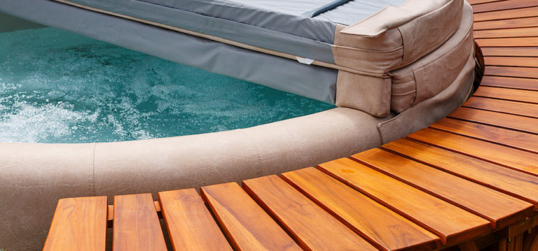 The ultimate garden accessory a free standing cedar wood hot tub with cover.