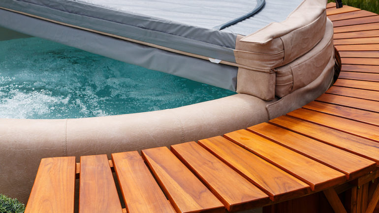 The ultimate garden accessory a free standing cedar wood hot tub with cover.