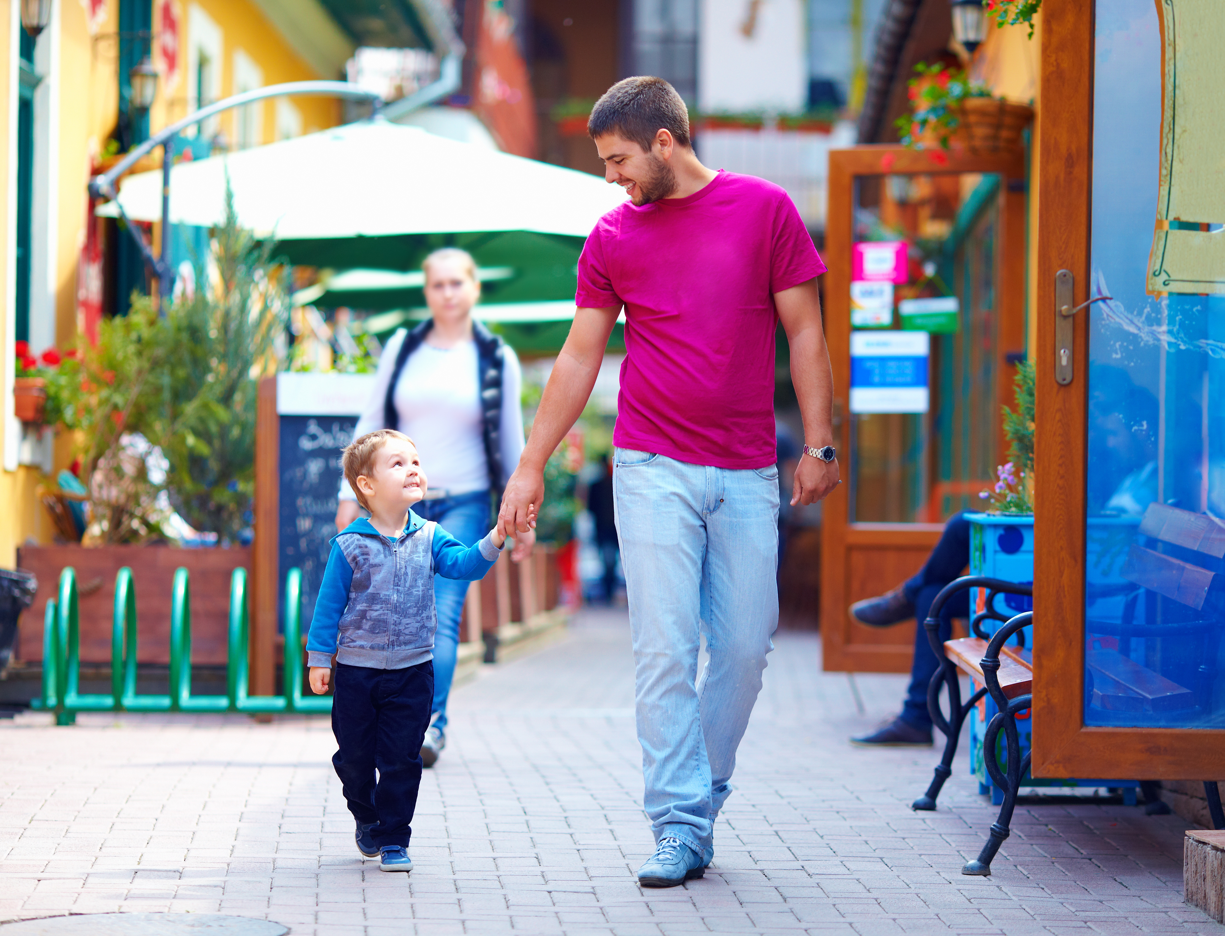 A happy father and son walking the city street settling into a new community.