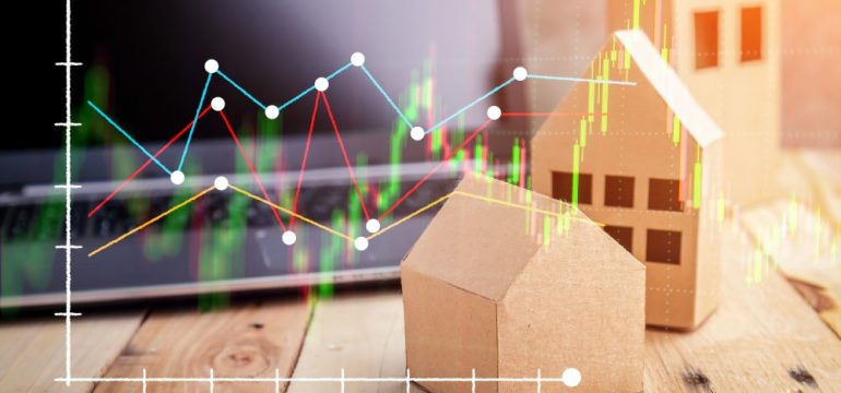 Real estate models on the top of wooden floor. Wooden house, building, and home. Flat design with graph with graph representing housing statistics for real estate industry.