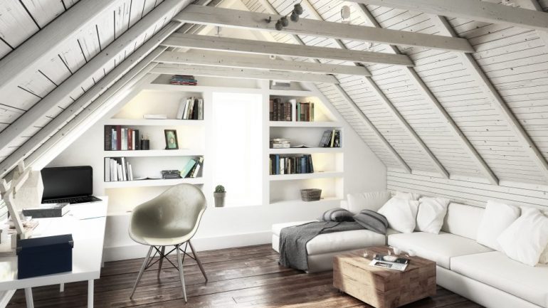 Attic conversion to a bright living space with white decor.