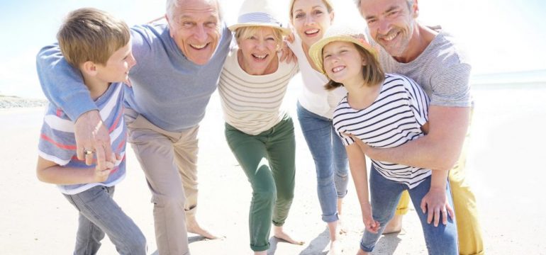 Portrait of happy multi-generational family having fun on the beach.