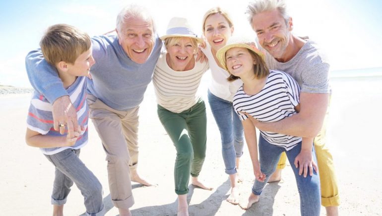 Portrait of happy multi-generational family having fun on the beach.