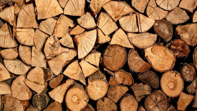 Chopped firewood in a stack. Firewood prepared for heating the home during winter.