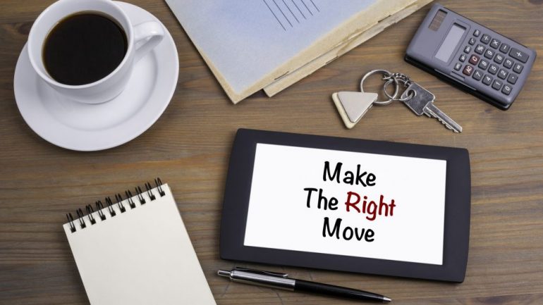 "Make the Right Move" text on tablet device on a wooden table provides advice to someone that is relocating.