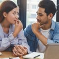 New home buyer couple showing the concept of discussing the subject of financing your first home.