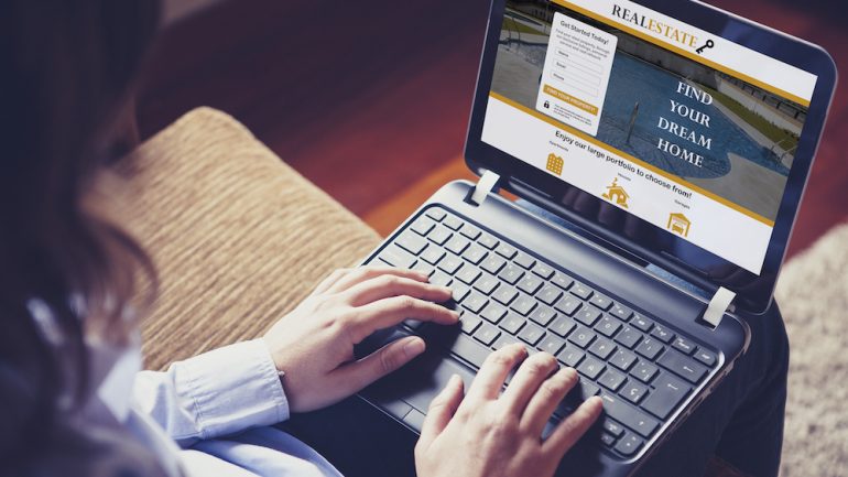 Woman shopping for a home on her laptop computer at home during coronavirus pandemic.