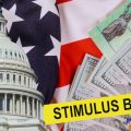 The CARES Act provides Coronavirus financial relief checks from the US government during the coronavirus crisis. Picture of US dollar, US Treasury check and US Capitol building cash on the American flag.