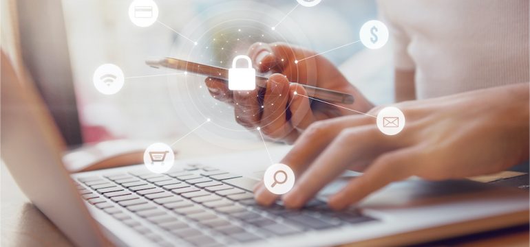 Woman using smartphone and laptop with icon graphic of security network representing protecting herself from online shopping scams.