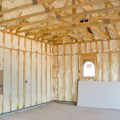 A garage ceiling and walls at a newly constructed home is sprayed with liquid insulating foam before the drywall is added.