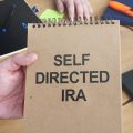 Business photo shows handwritten text self-directed IRA.