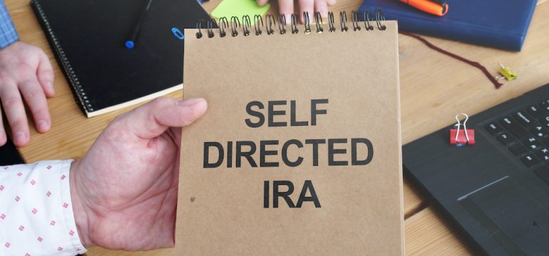 Business photo shows handwritten text self-directed IRA.