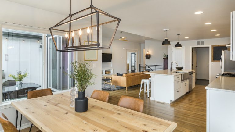 Modern farmhouse design dining area open to kitchen.