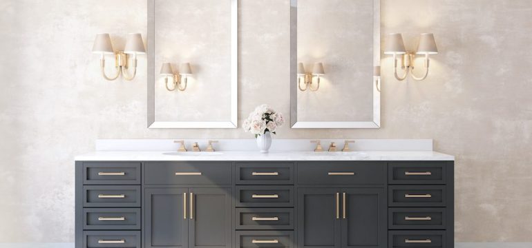 Classic luxury bathroom with marble floor, brass fixtures and dark vanity cabinets.