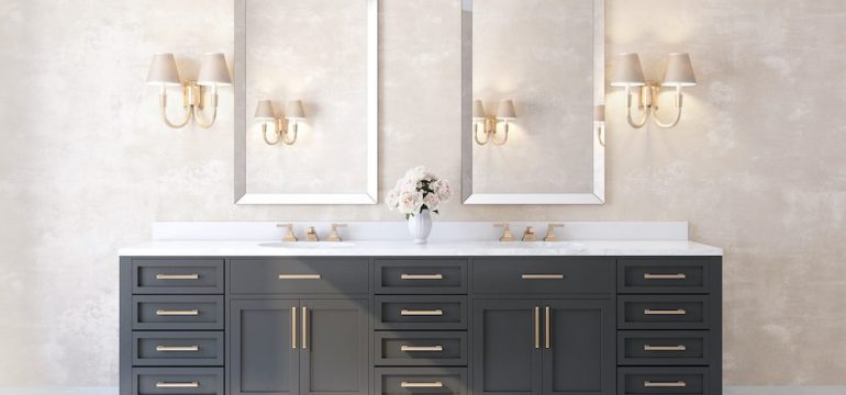 Classic luxury bathroom with marble floor, brass fixtures and dark vanity cabinets.