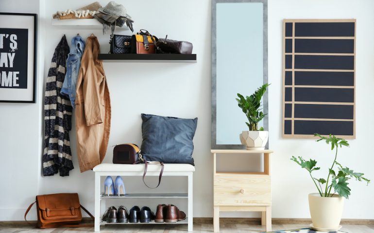 Functional entryway with large mirror, coat hooks and shoe rack.