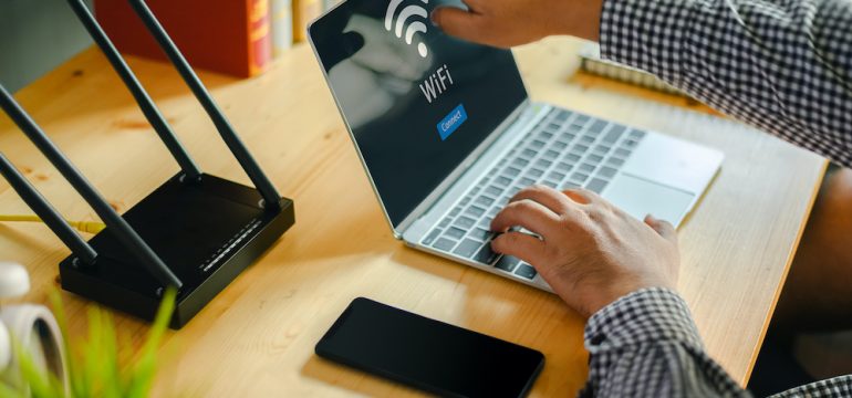 Young man ready to shut down his home computer network on laptop after Internet and social media access.