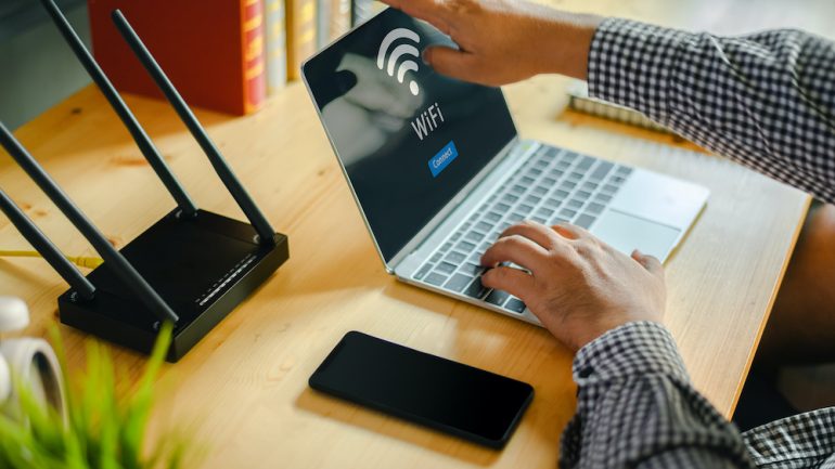 Young man ready to shut down his home computer network on laptop after Internet and social media access.