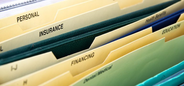 Close up of personal financial life files in expanding pocket folders