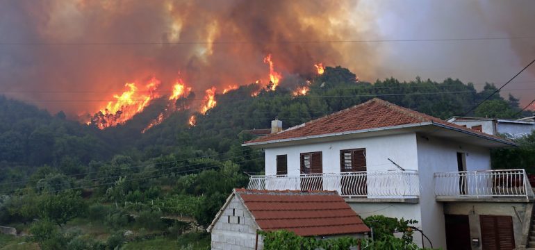 Massive wildfire burning down the forest and wildfire smoke threatens the indoor air quality for homeowners in the area.