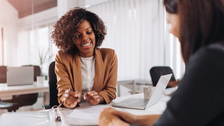 Female client consulting with a real estate attorney in the office.