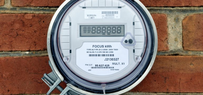 Image of electrical power meter on outside wall of brick wall calculating the idle load drawn by the home.