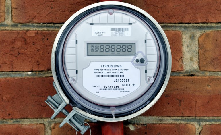 Image of electrical power meter on outside wall of brick wall calculating the idle load drawn by the home.