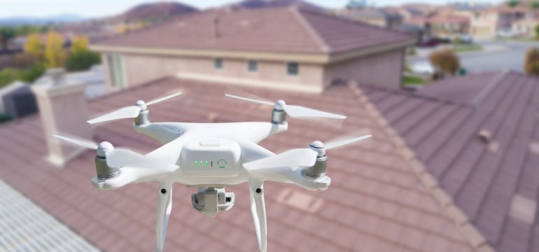 Drone In the air over a house Inspecting the roof.