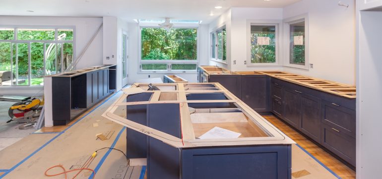 Cutting and marking wood templates for making countertops in kitchen remodel.