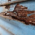 An old house with wood rot on exterior from termites and sun exposure.
