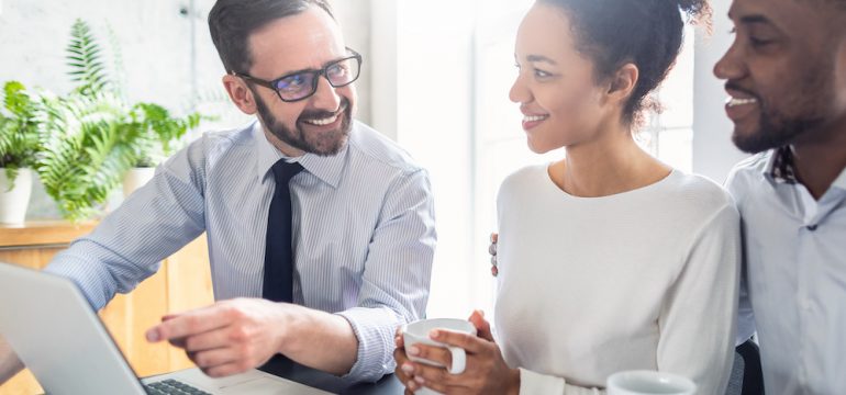 A couple consults with a lawyer or real estate agent after making an offer to buy a house.