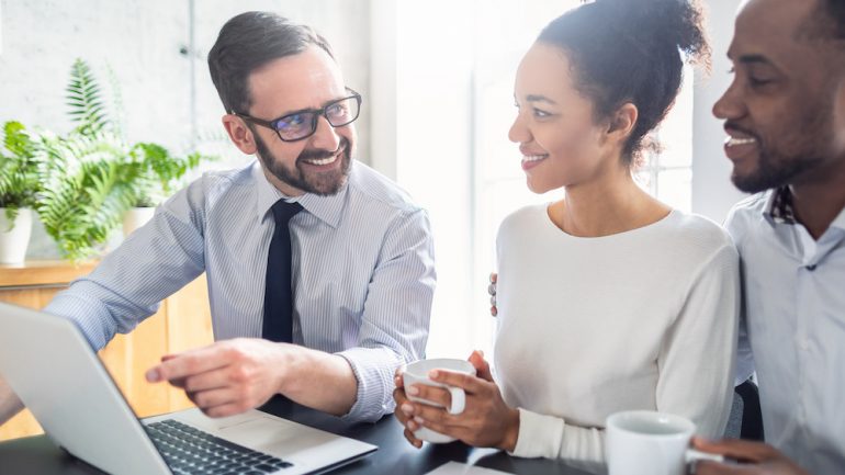 A couple consults with a lawyer or real estate agent after making an offer to buy a house.