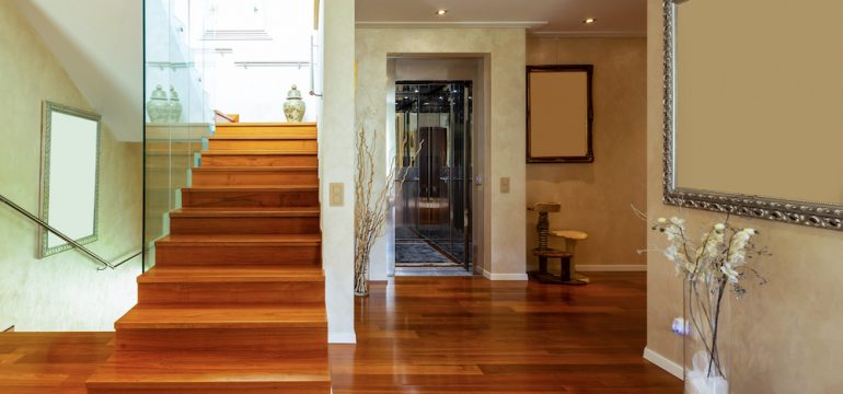 Entry of home with stairs parquet floors and home elevators.