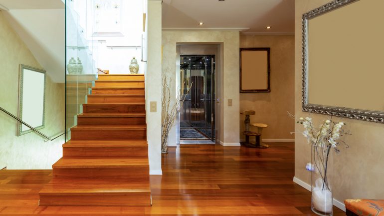 Entry of home with stairs parquet floors and home elevators.