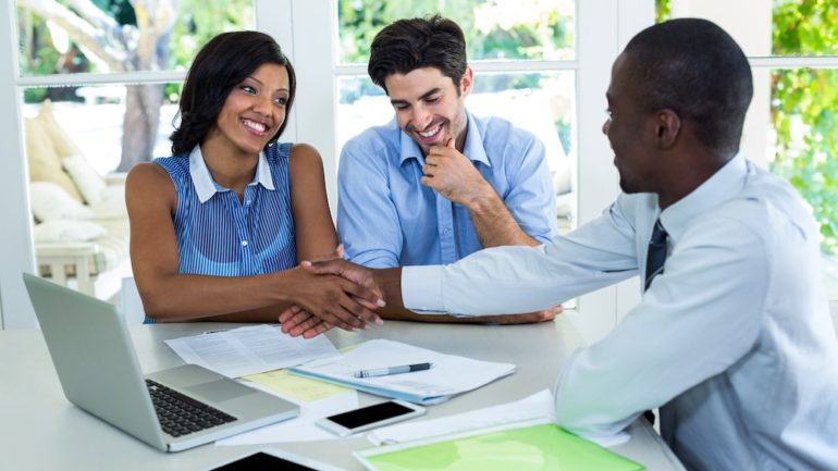 Happy couple that recognize the value of a real estate agent