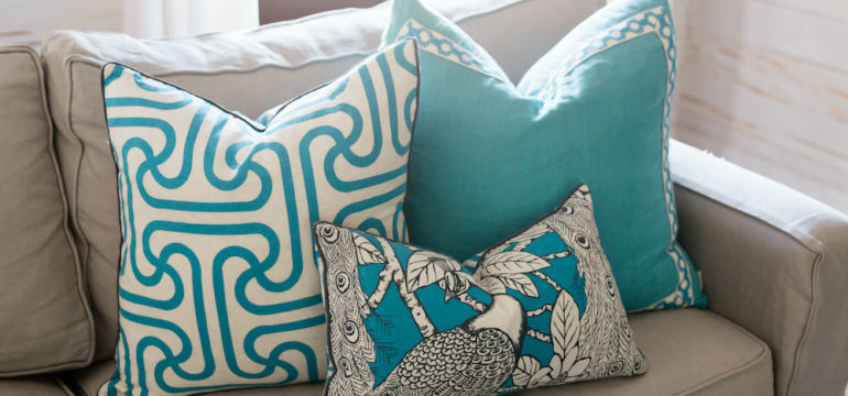 Cozy beach house living room with blue decorative sofa pillows.