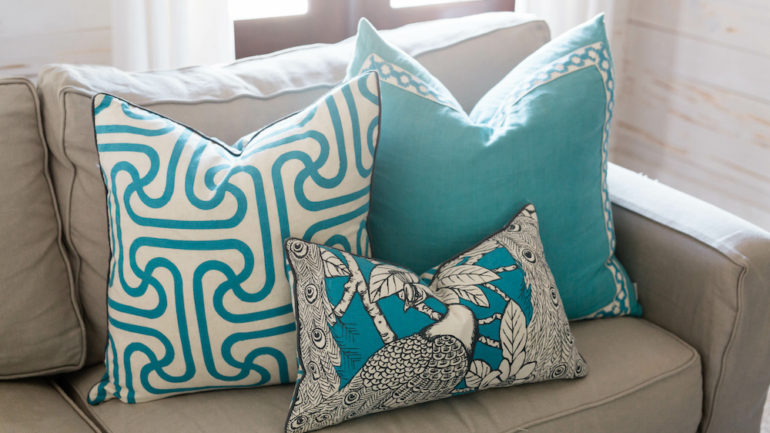 Cozy beach house living room with blue decorative sofa pillows.