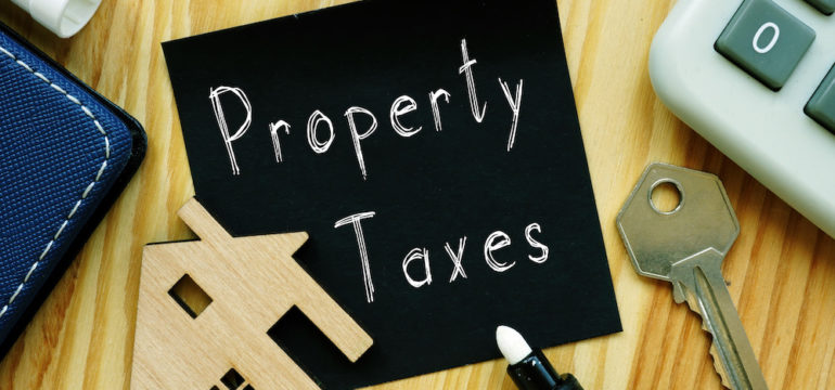 Terms related to property tax appraisal are shown on a blackboard.